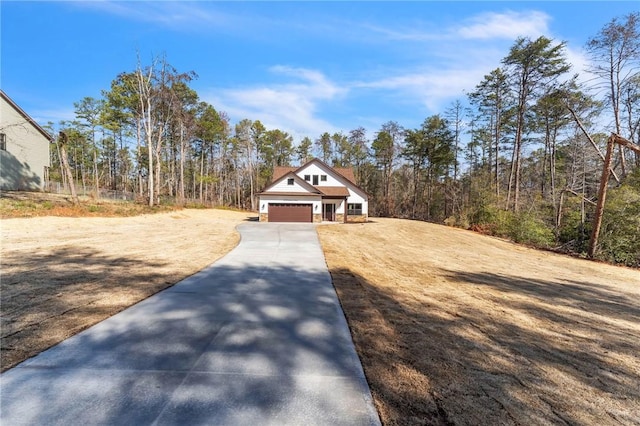 view of front of property with concrete driveway and an attached garage