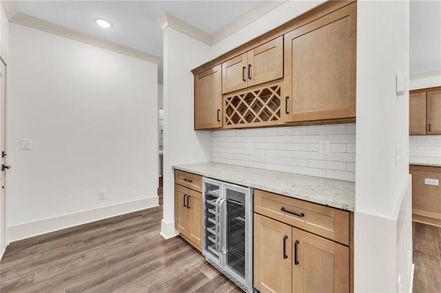 bar featuring decorative backsplash, wine cooler, light wood-type flooring, and a dry bar