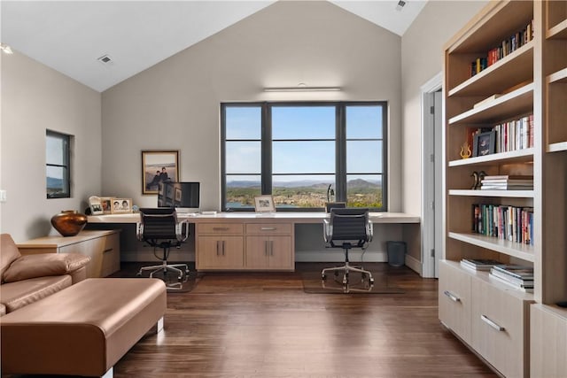 office area featuring baseboards, built in desk, dark wood-style flooring, and high vaulted ceiling