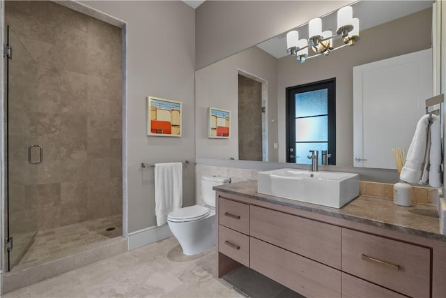 full bathroom featuring vanity, toilet, a stall shower, and a chandelier