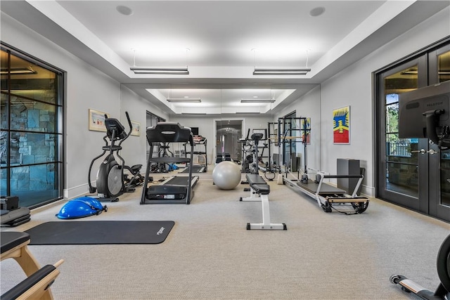 gym with french doors and baseboards