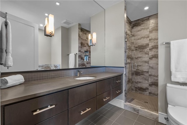 bathroom with vanity, visible vents, tile patterned flooring, a shower stall, and toilet