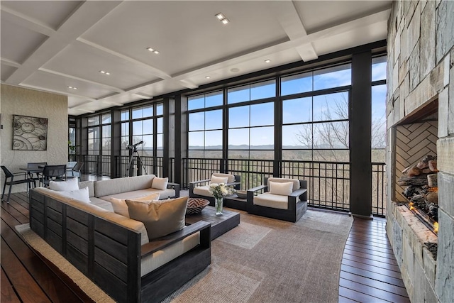 living room featuring hardwood / wood-style flooring, plenty of natural light, coffered ceiling, and expansive windows