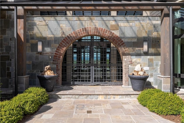 property entrance with stone siding