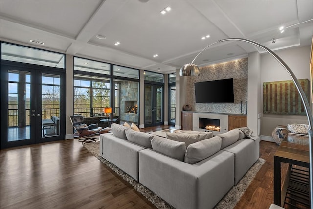 living room with baseboards, a large fireplace, and dark wood finished floors