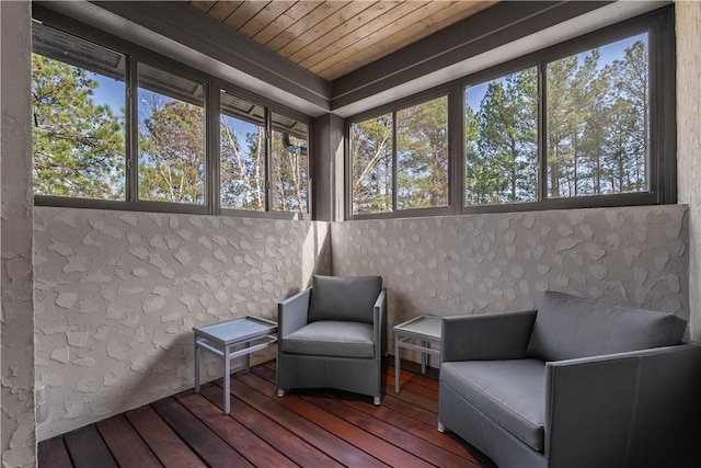 sunroom / solarium featuring a healthy amount of sunlight and wood ceiling