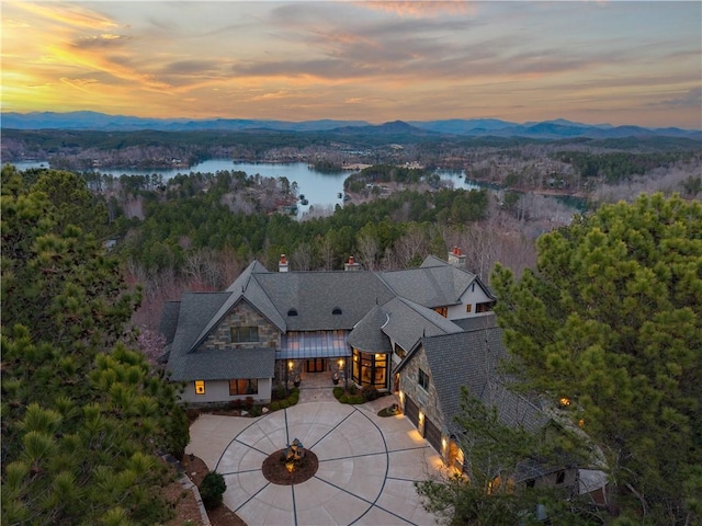 aerial view with a forest view and a water and mountain view