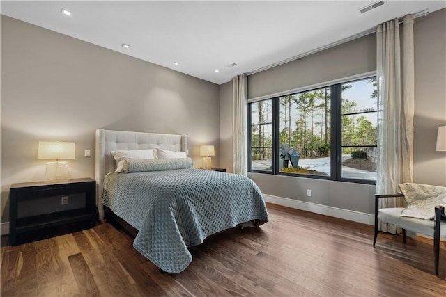 bedroom with recessed lighting, wood finished floors, visible vents, and baseboards