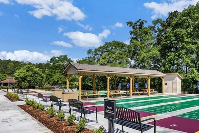 view of home's community featuring an outbuilding and shuffleboard