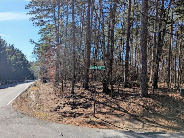 view of street with a wooded view