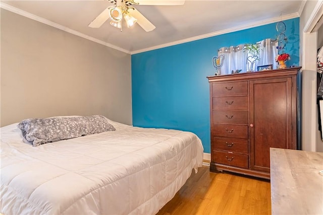 bedroom with crown molding, a ceiling fan, and wood finished floors