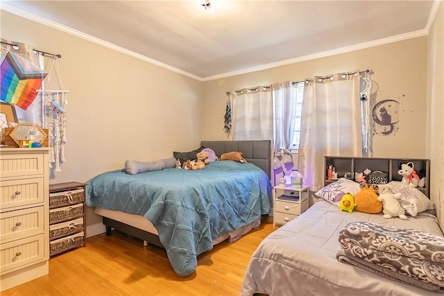 bedroom featuring light wood-style floors and ornamental molding