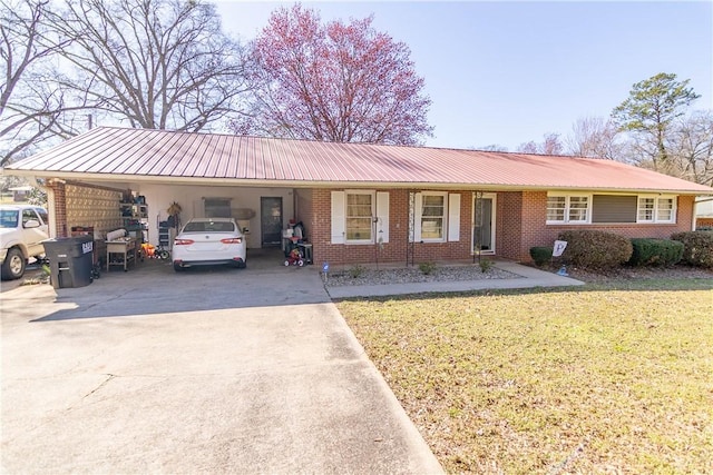 single story home with an attached carport, concrete driveway, a front yard, metal roof, and brick siding