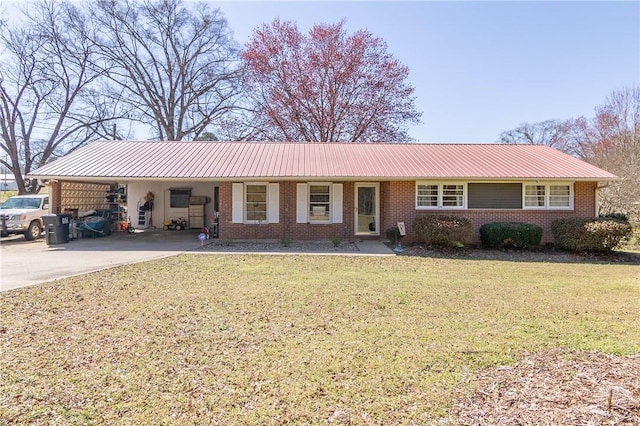 ranch-style house with brick siding, an attached carport, a front lawn, metal roof, and driveway