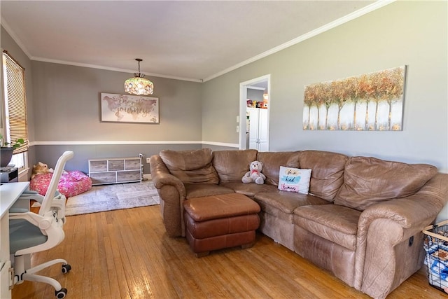 living room with wood-type flooring and ornamental molding