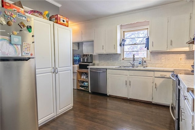 kitchen featuring a sink, stainless steel appliances, light countertops, and white cabinetry