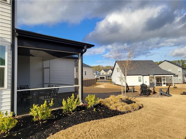 view of yard with a residential view and a patio