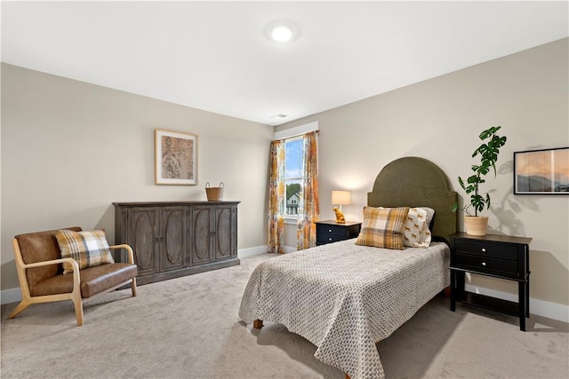 carpeted bedroom with baseboards