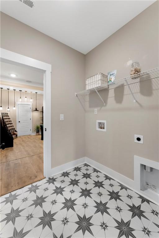 clothes washing area featuring laundry area, hookup for a washing machine, baseboards, and electric dryer hookup