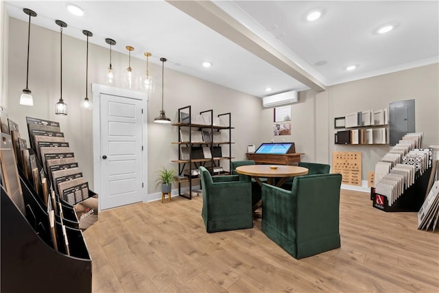 game room featuring recessed lighting, baseboards, light wood-style floors, and a wall unit AC