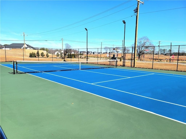 view of sport court featuring fence