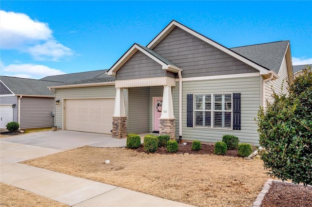 craftsman house with concrete driveway and a garage