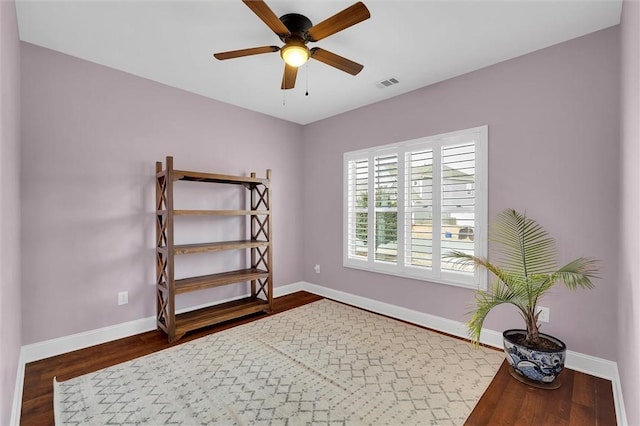 interior space featuring visible vents, baseboards, and wood finished floors