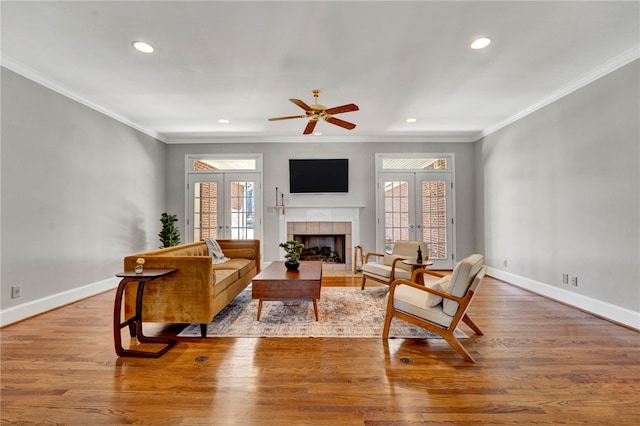 living room with french doors, baseboards, wood finished floors, and ornamental molding