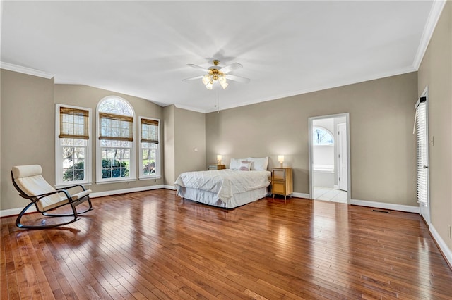 bedroom with multiple windows, baseboards, and wood-type flooring