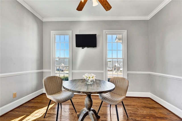 dining area with baseboards, plenty of natural light, wood finished floors, and ornamental molding