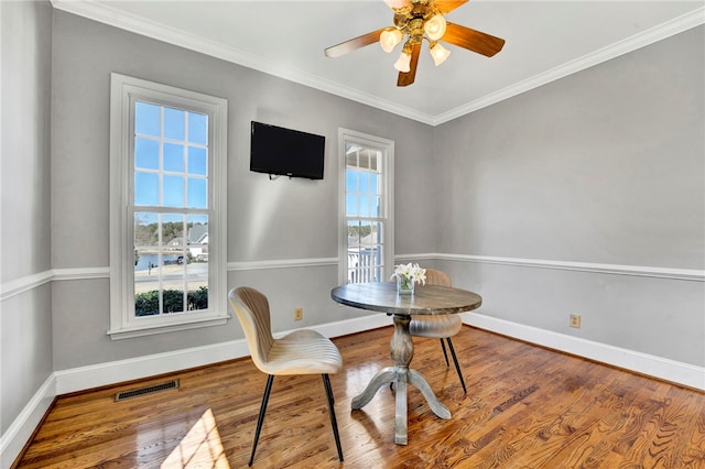 dining space with visible vents, baseboards, a healthy amount of sunlight, and wood finished floors