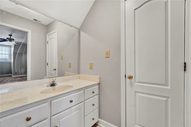 bathroom with baseboards, visible vents, vanity, and ceiling fan