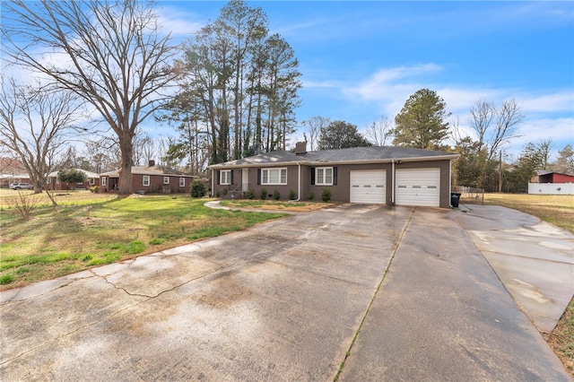 ranch-style home with a front lawn, concrete driveway, and a garage