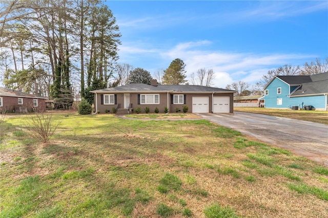 ranch-style house with a front lawn, concrete driveway, and a garage