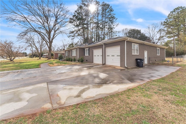 view of front of home with a front yard, driveway, a chimney, a garage, and brick siding