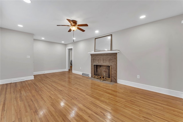 unfurnished living room featuring visible vents, a brick fireplace, baseboards, recessed lighting, and light wood-style flooring