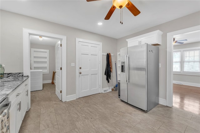 kitchen featuring light stone countertops, baseboards, ceiling fan, appliances with stainless steel finishes, and white cabinetry