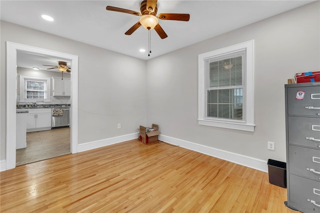 empty room featuring recessed lighting, light wood-style flooring, a ceiling fan, and baseboards