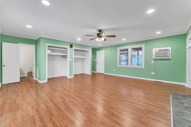 unfurnished bedroom with recessed lighting, light wood-type flooring, a wall mounted air conditioner, and ornamental molding