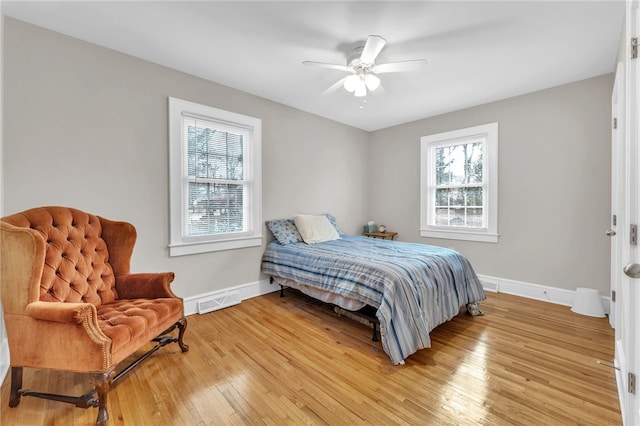 bedroom with visible vents, baseboards, light wood-type flooring, and ceiling fan