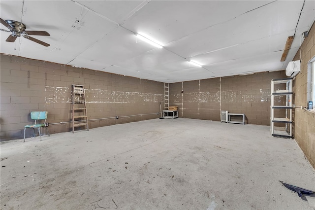 garage featuring a wall mounted air conditioner and concrete block wall