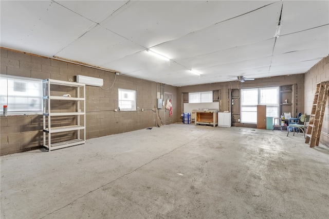 interior space with concrete block wall and a wall mounted air conditioner