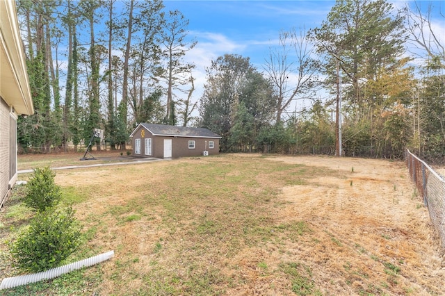 view of yard featuring an outdoor structure and fence