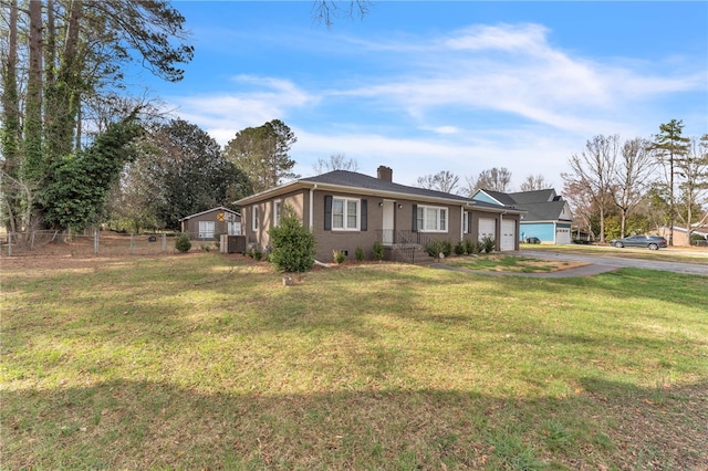 view of front of home with central air condition unit, fence, a front yard, an attached garage, and a chimney