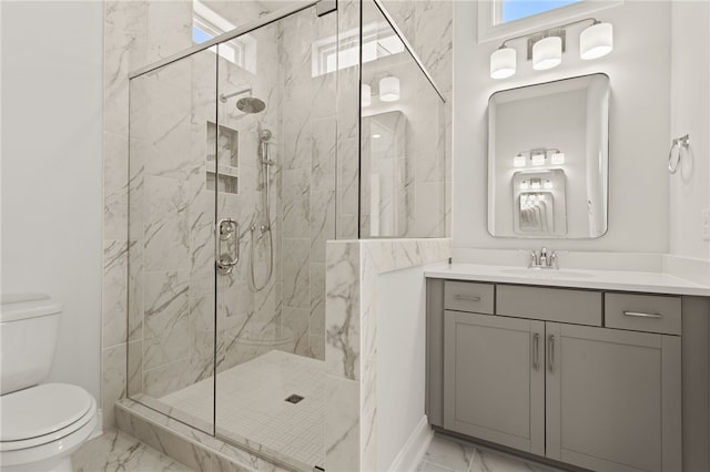 bathroom featuring toilet, marble finish floor, and a marble finish shower