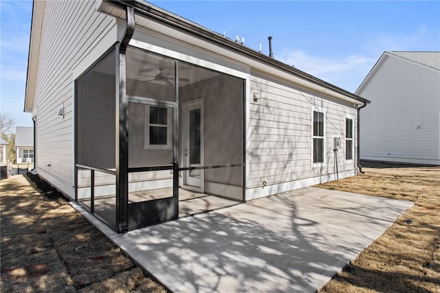 rear view of property featuring a patio and a sunroom