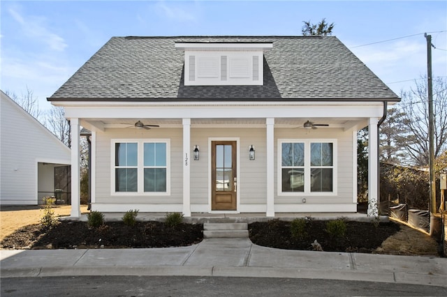 bungalow-style house with a porch, roof with shingles, and ceiling fan