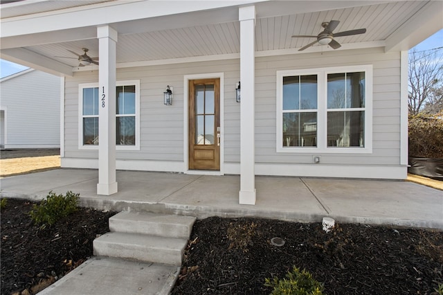 entrance to property with a porch and a ceiling fan