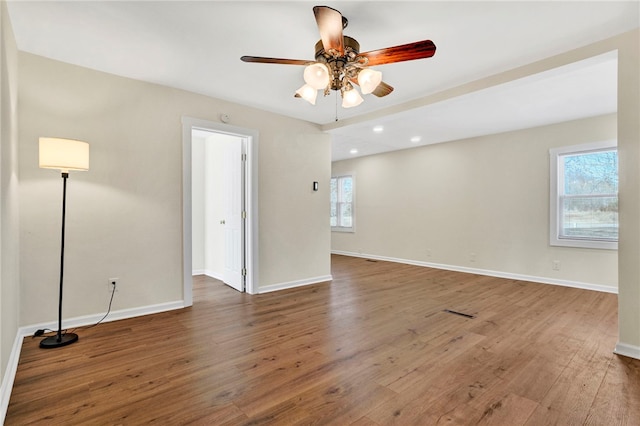 empty room with hardwood / wood-style floors, recessed lighting, baseboards, and ceiling fan