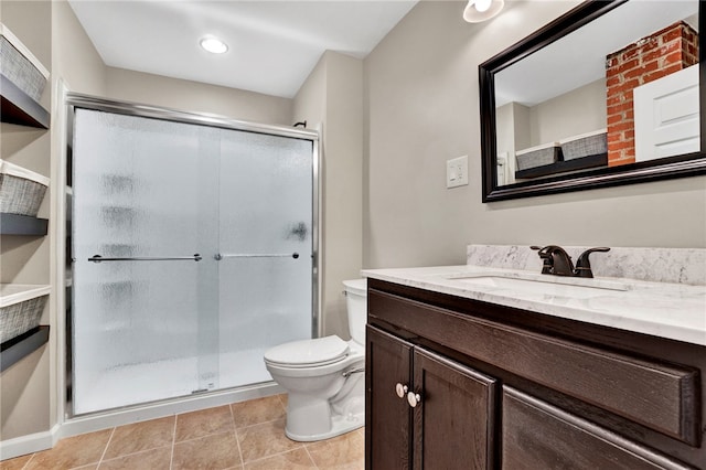 bathroom featuring vanity, toilet, a shower stall, and tile patterned flooring